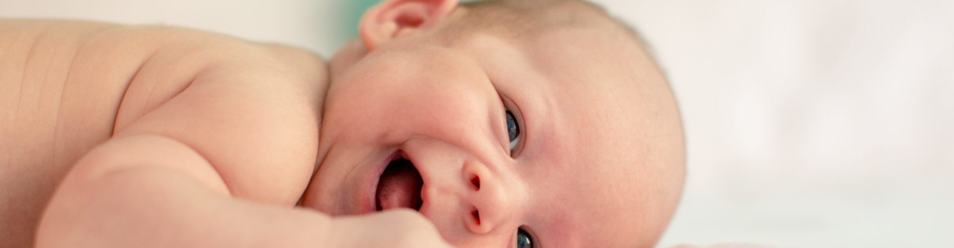 baby lying on fabric cloth